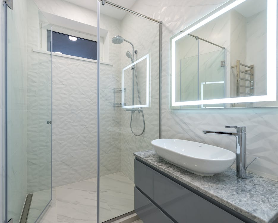 a sleek marble countertop and a glass shower door