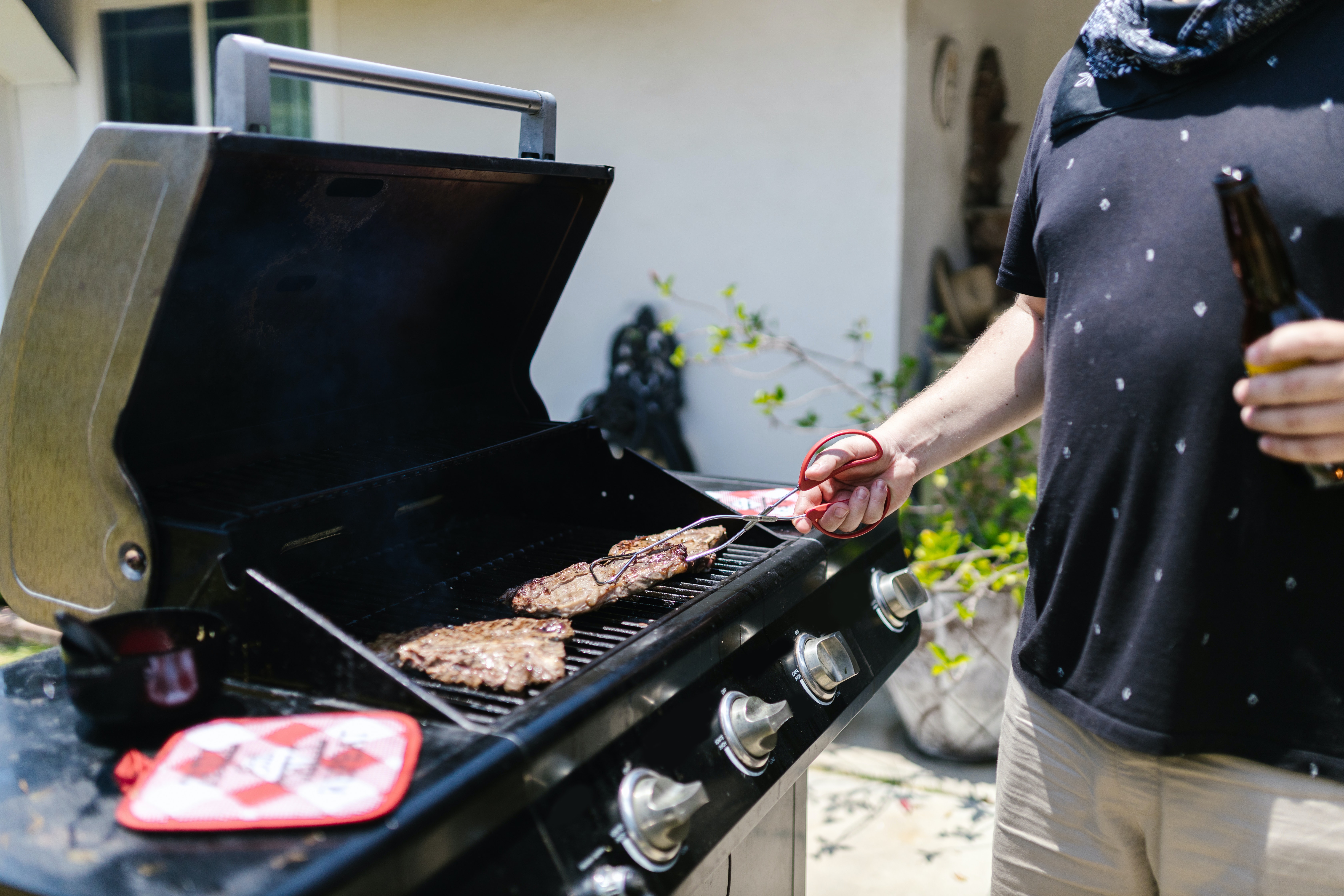  A person making hamburgers with the help of a grill