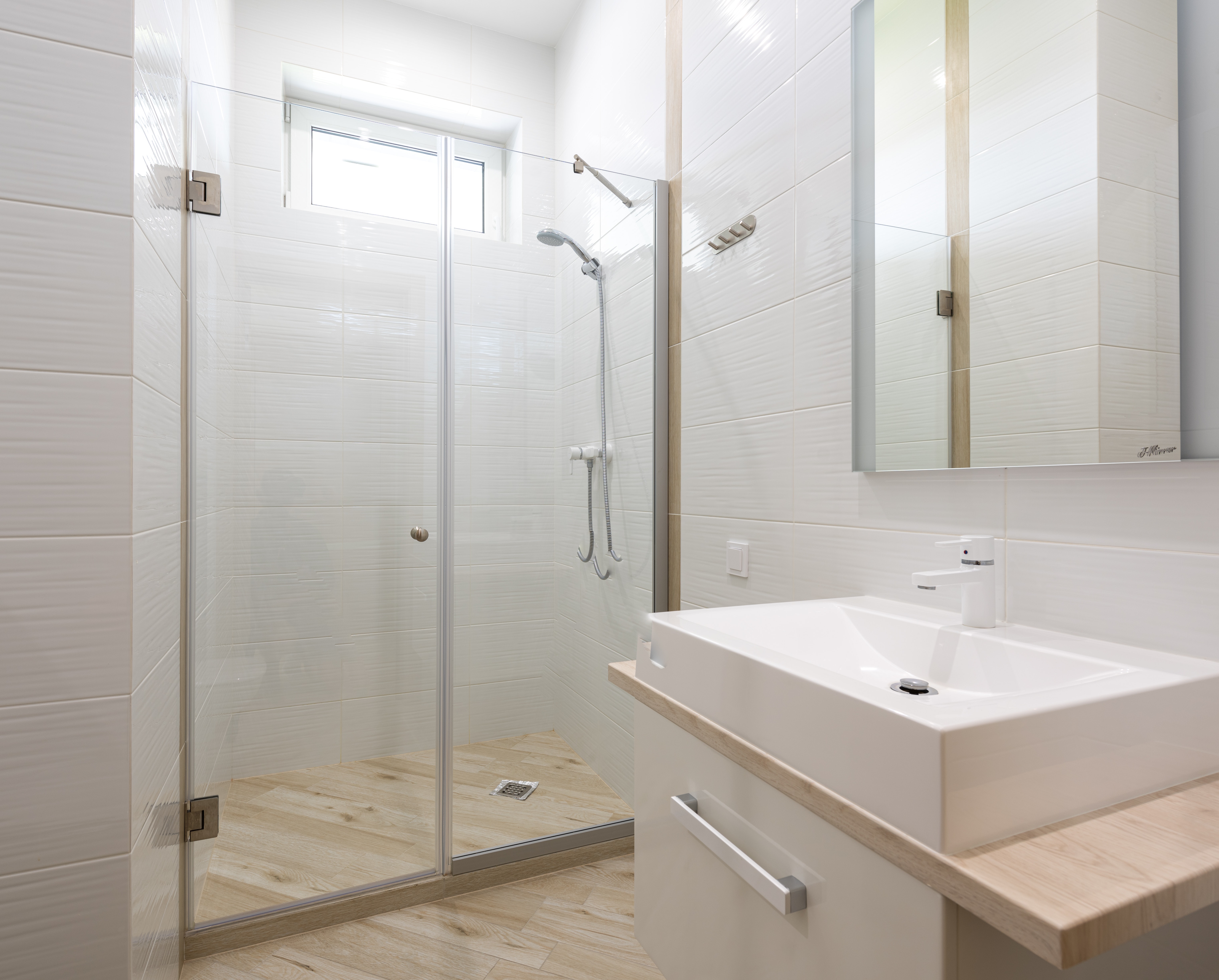A frameless glass shower panel installed by professionals