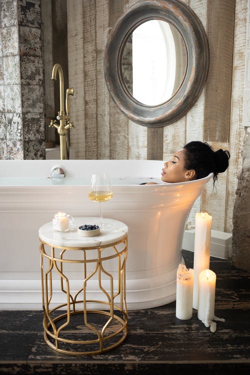  A woman lying in a bathtub 